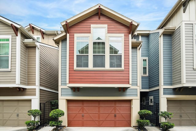 multi unit property featuring an attached garage, fence, and concrete driveway