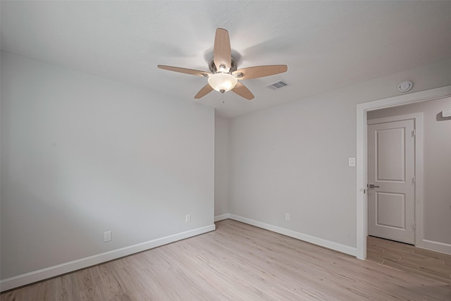 unfurnished room featuring baseboards, a ceiling fan, light wood-style flooring, and visible vents