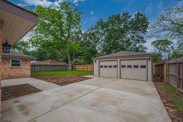 detached garage featuring fence