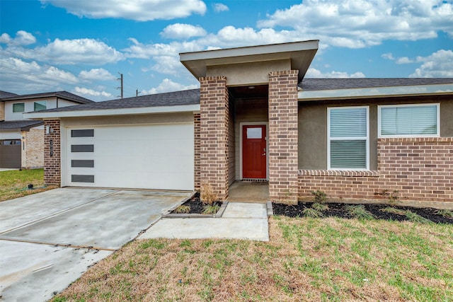 3907 Itzle Island Ct, Katy, TX 77494 - view of front facade featuring brick siding, an attached garage, driveway, and a front yard