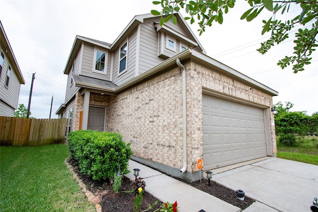 view of home's exterior featuring a lawn, an attached garage, fence, and concrete driveway