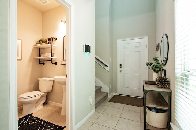bathroom with tile patterned floors, baseboards, toilet, and visible vents