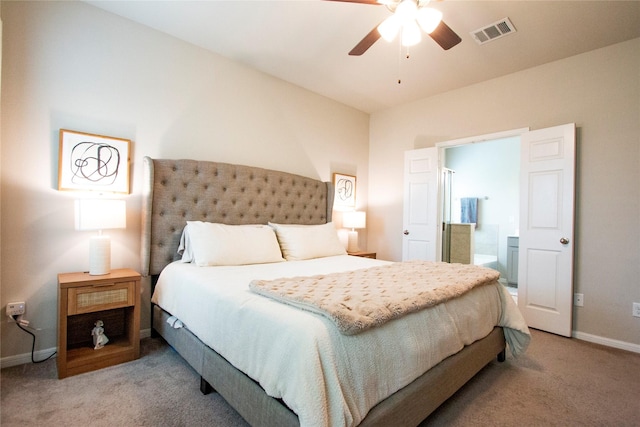 bedroom featuring light colored carpet, baseboards, visible vents, and ensuite bathroom