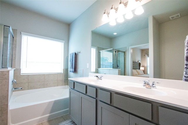 ensuite bathroom featuring visible vents, connected bathroom, tile patterned floors, a shower stall, and a sink