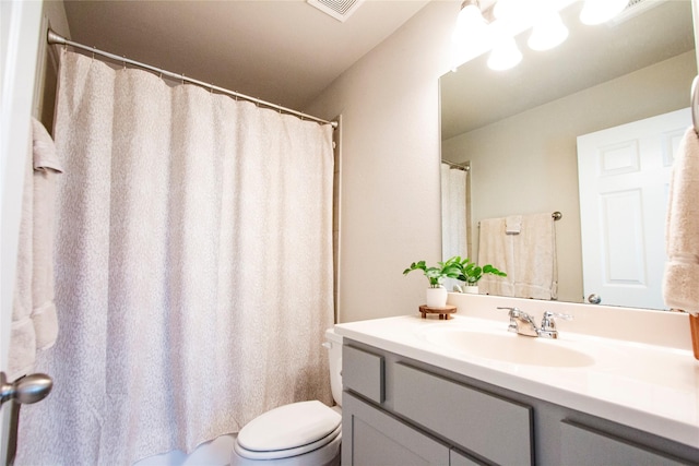 bathroom featuring vanity, a shower with shower curtain, toilet, and visible vents