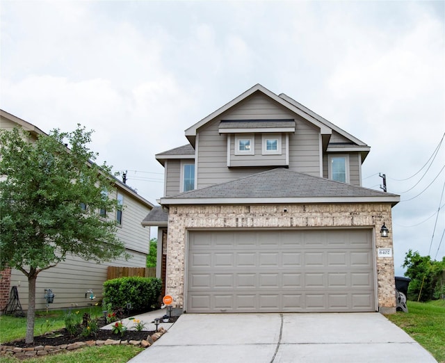 traditional home with concrete driveway, a shingled roof, and a garage