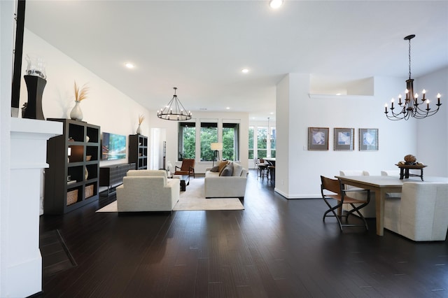 living room with dark wood-style flooring, an inviting chandelier, and recessed lighting