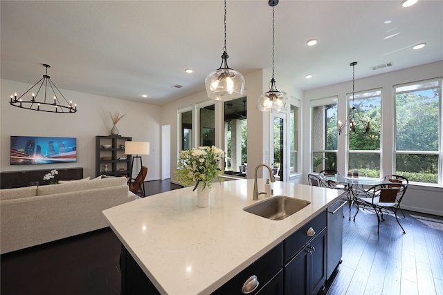 kitchen featuring a sink, a healthy amount of sunlight, a notable chandelier, and visible vents