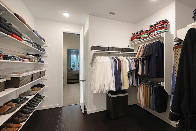 spacious closet with visible vents and dark wood-type flooring