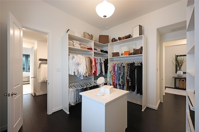 walk in closet featuring dark wood finished floors and visible vents