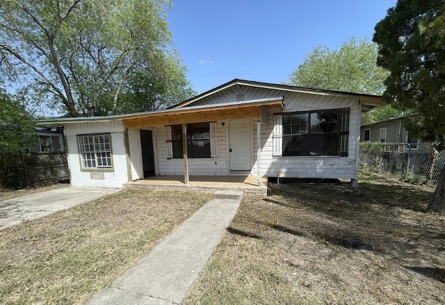 bungalow-style home with fence and covered porch
