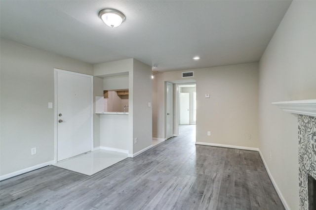 unfurnished room with recessed lighting, baseboards, visible vents, and wood finished floors