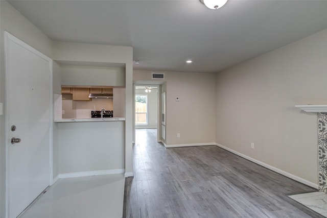 unfurnished living room with visible vents, baseboards, ceiling fan, recessed lighting, and light wood finished floors