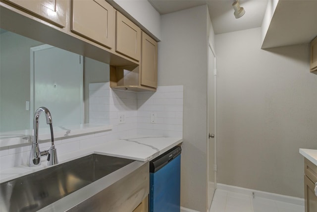 kitchen featuring light stone countertops, a sink, dishwasher, baseboards, and backsplash