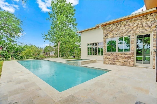 view of pool featuring a pool with connected hot tub and a patio area