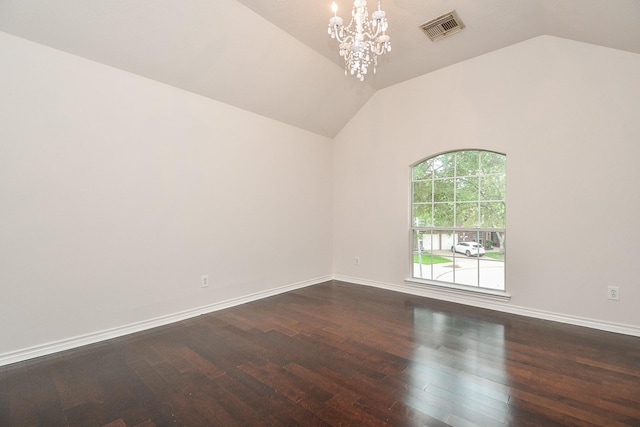 spare room with a notable chandelier, visible vents, dark wood-style floors, and vaulted ceiling