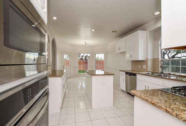 kitchen featuring an inviting chandelier, visible vents, white cabinets, a sink, and appliances with stainless steel finishes