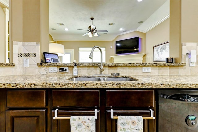 kitchen featuring a sink, light stone counters, a ceiling fan, and dishwasher