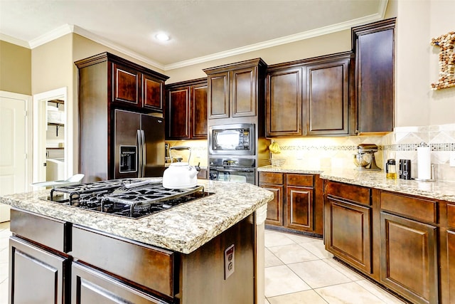 kitchen with crown molding, light stone counters, tasteful backsplash, a kitchen island, and black appliances