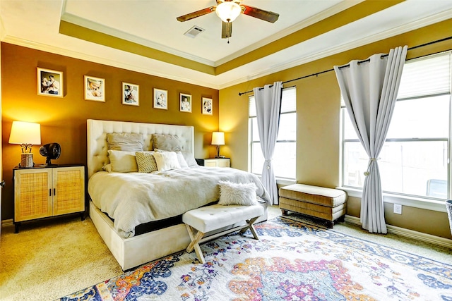 carpeted bedroom featuring crown molding, a ceiling fan, baseboards, and visible vents