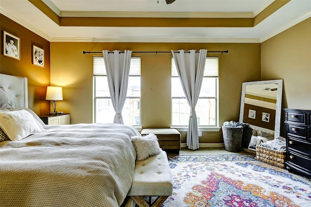 bedroom with crown molding, carpet flooring, and a raised ceiling