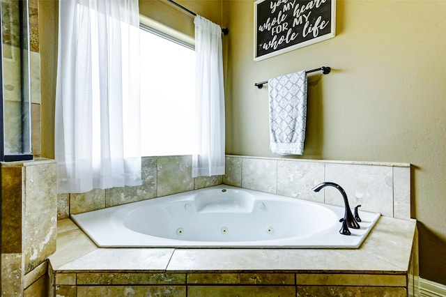 bathroom with a tub with jets