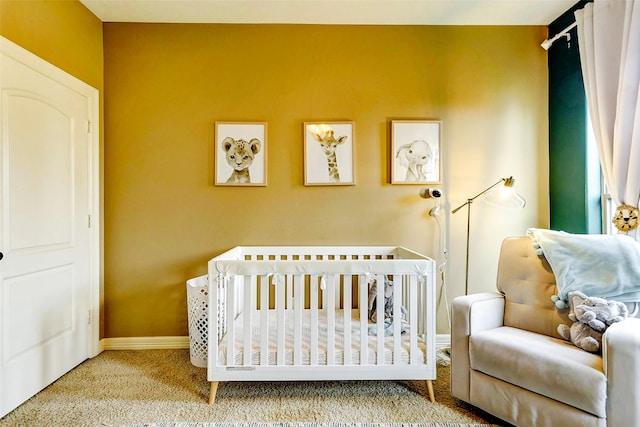 bedroom featuring carpet floors, baseboards, and a nursery area