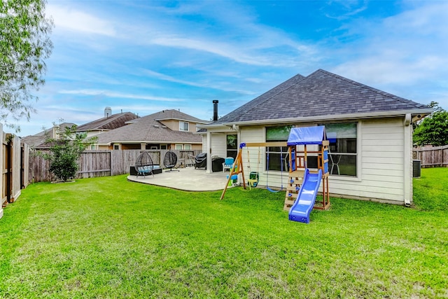 back of house with roof with shingles, a patio, a yard, and a fenced backyard
