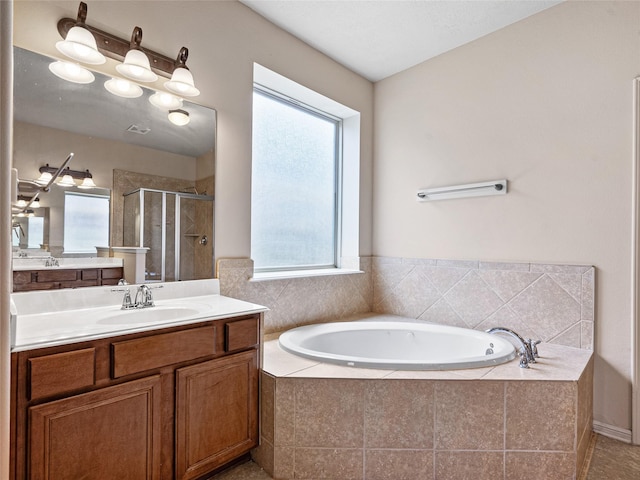 bathroom with vanity, a bath, and a shower stall
