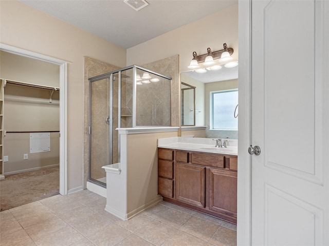 full bath featuring visible vents, tile patterned flooring, vanity, a spacious closet, and a stall shower