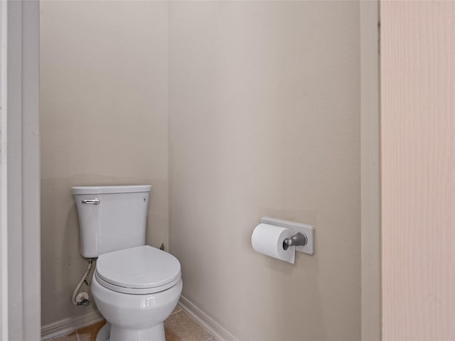 bathroom featuring baseboards and toilet