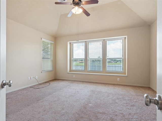 carpeted empty room featuring baseboards, ceiling fan, and lofted ceiling