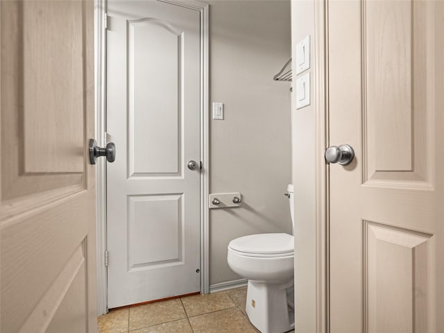 bathroom featuring tile patterned flooring and toilet