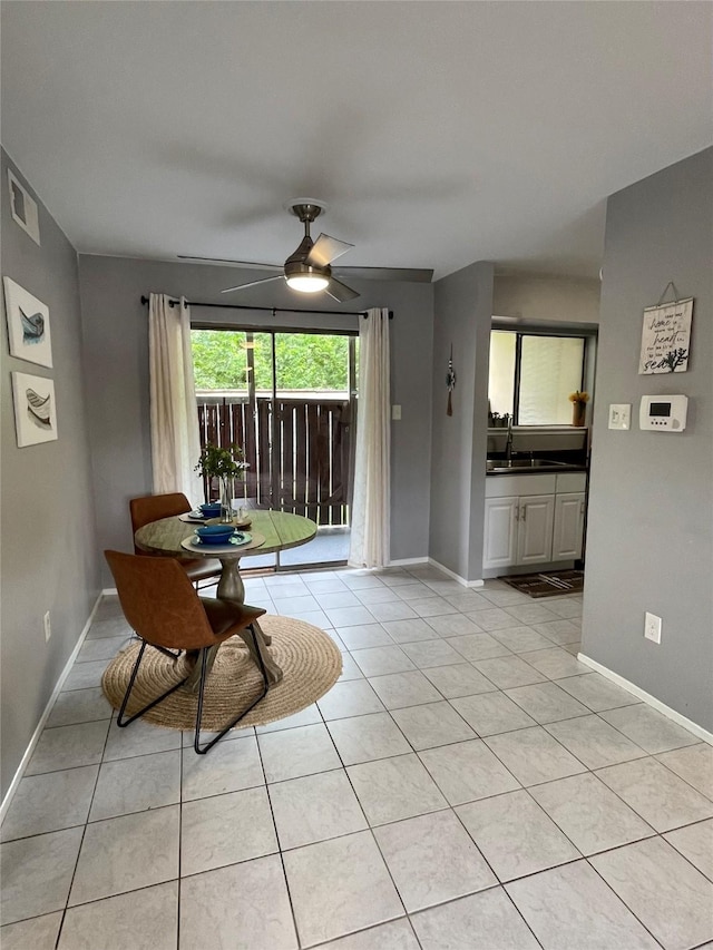 interior space featuring light tile patterned flooring, ceiling fan, visible vents, and baseboards