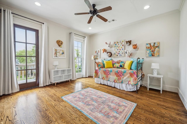 bedroom featuring visible vents, ornamental molding, wood finished floors, and access to exterior