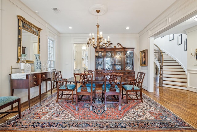 dining room with visible vents, wood finished floors, stairway, a chandelier, and recessed lighting