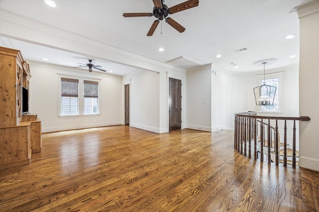unfurnished living room with crown molding, baseboards, ceiling fan, and wood finished floors