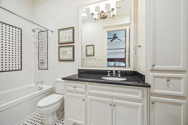bathroom featuring vanity, washtub / shower combination, tile patterned floors, and toilet