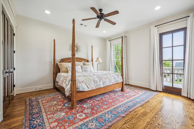 bedroom with visible vents, ornamental molding, baseboards, and wood finished floors