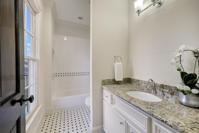 bathroom featuring toilet, baseboards, shower / tub combination, and vanity