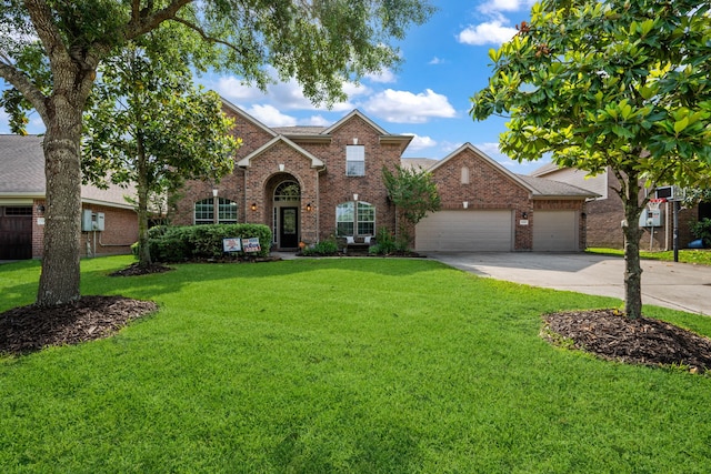 traditional-style home featuring an attached garage, driveway, a front lawn, and brick siding
