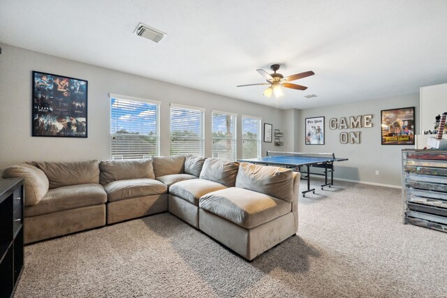 living area featuring baseboards, a ceiling fan, carpet flooring, and visible vents