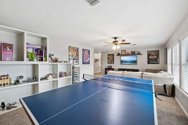 playroom featuring baseboards, carpet, a ceiling fan, and visible vents