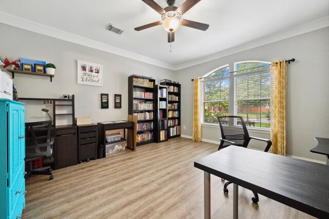home office featuring visible vents, crown molding, baseboards, ceiling fan, and light wood finished floors