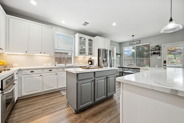 kitchen with gray cabinetry, appliances with stainless steel finishes, recessed lighting, and visible vents