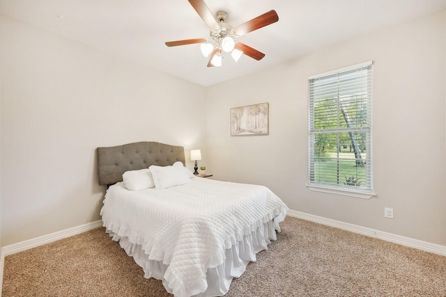 carpeted bedroom featuring a ceiling fan and baseboards