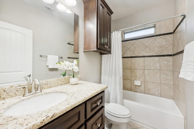 full bath featuring vanity, shower / bath combo with shower curtain, toilet, and visible vents