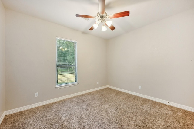 empty room featuring baseboards, light carpet, and ceiling fan