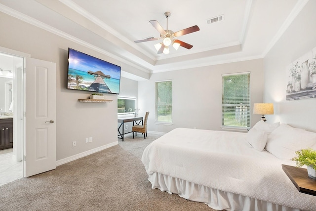 bedroom with visible vents, a raised ceiling, multiple windows, and light colored carpet