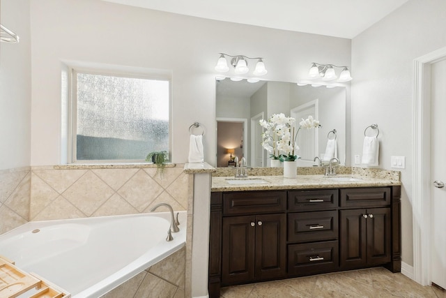 full bath featuring double vanity, a sink, a bath, and tile patterned flooring
